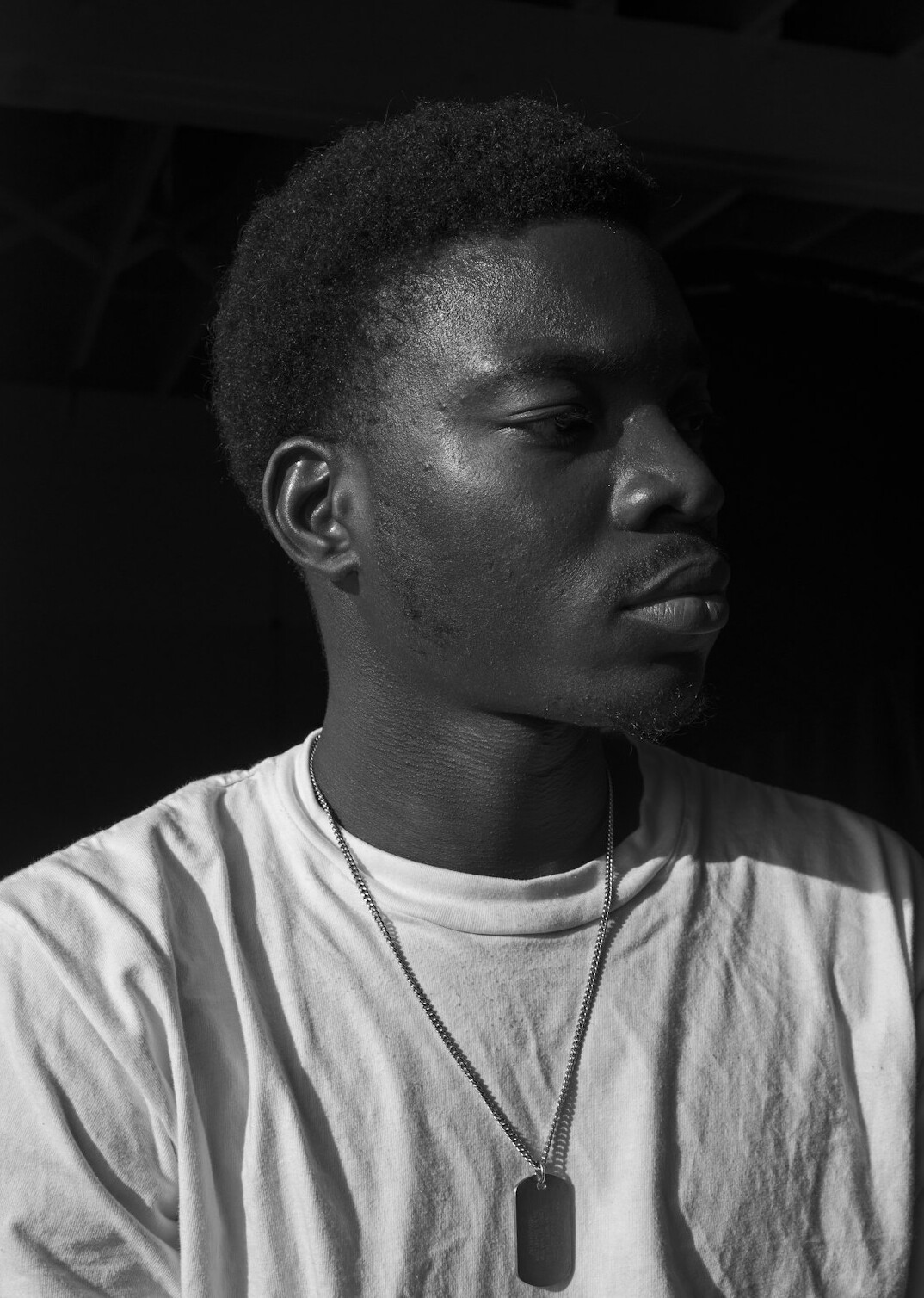 Studio portrait of a man with short hair and a light shirt