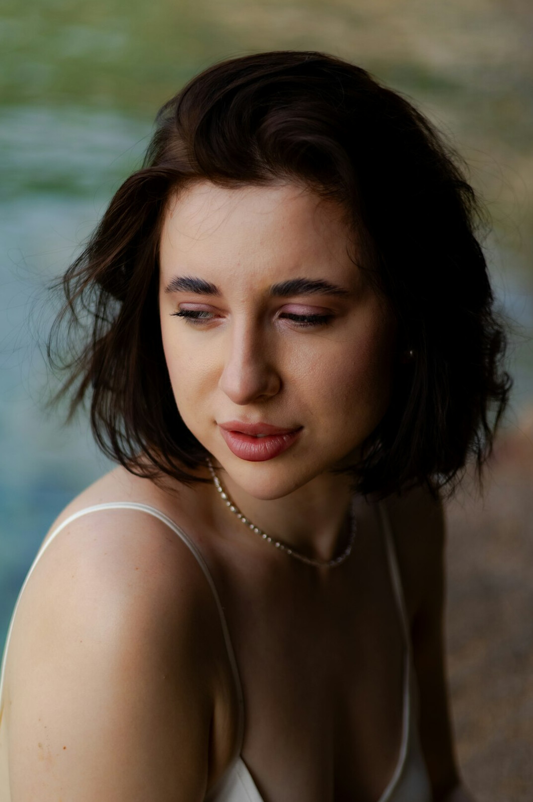 Portrait of a young woman with dark hair and a gentle smile