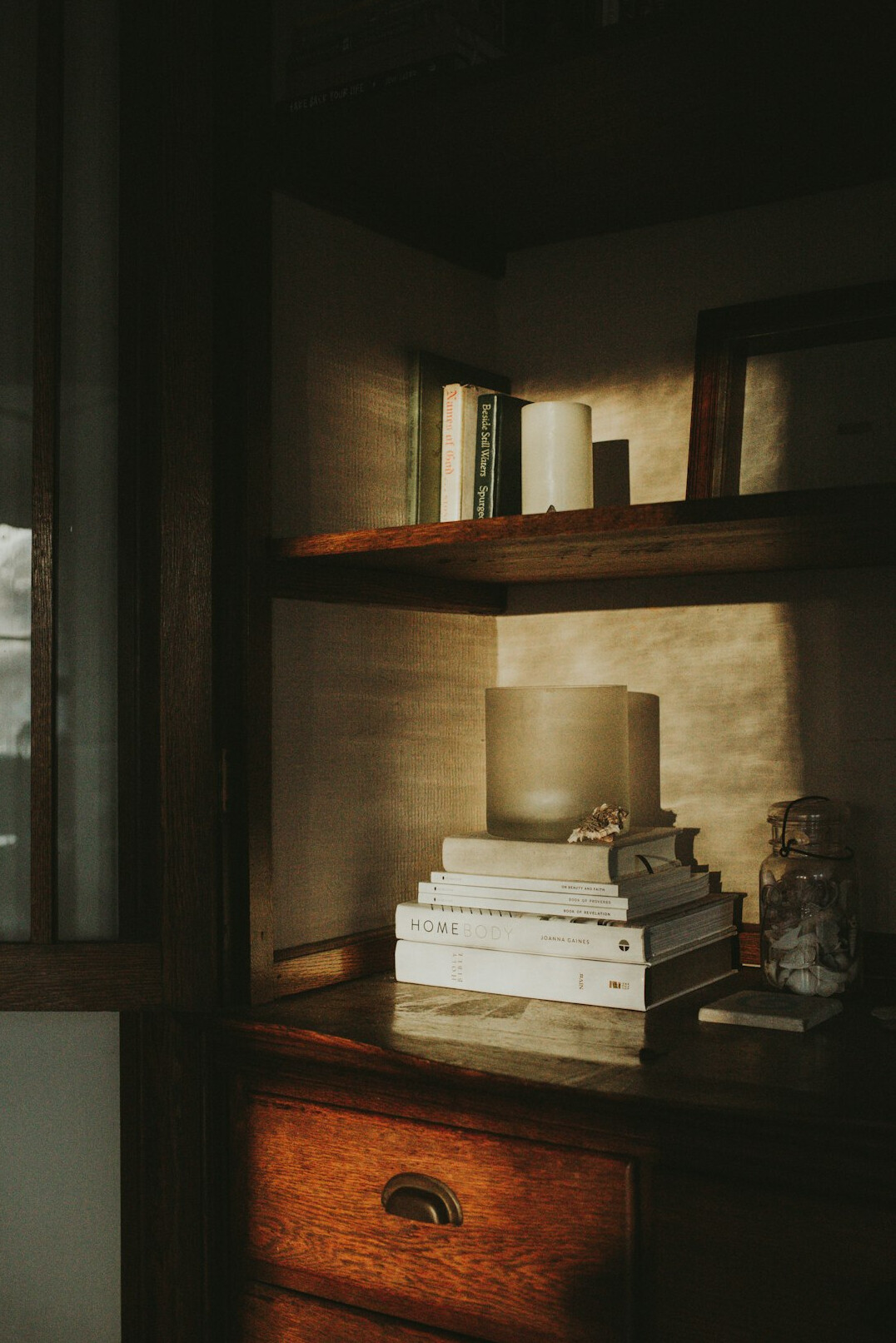 Stack of books and papers on a wooden research desk